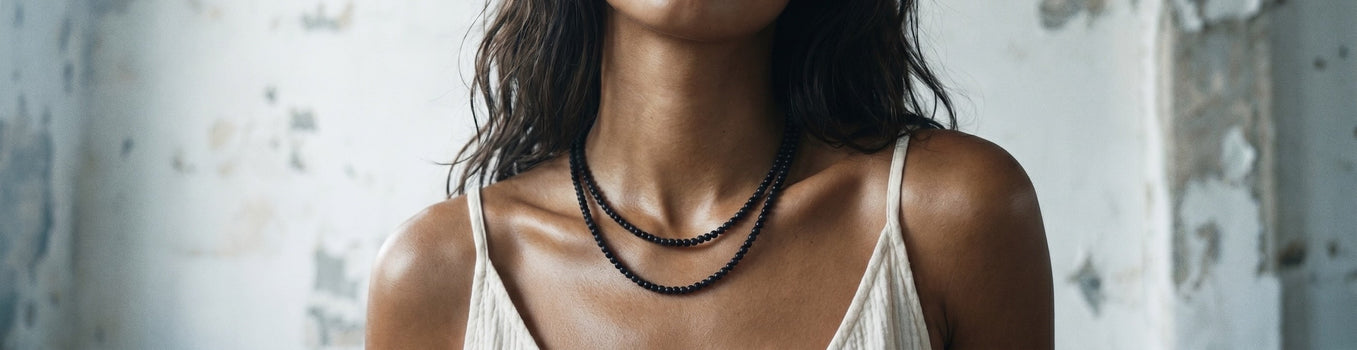 woman wearing handmade gemstone necklaces layered sterling silver jewelry