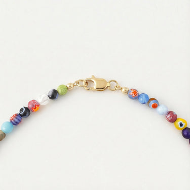Close-up of a men’s necklace with 6mm handmade vintage millefiori glass beads and a polished 14K gold-filled lobster clasp.