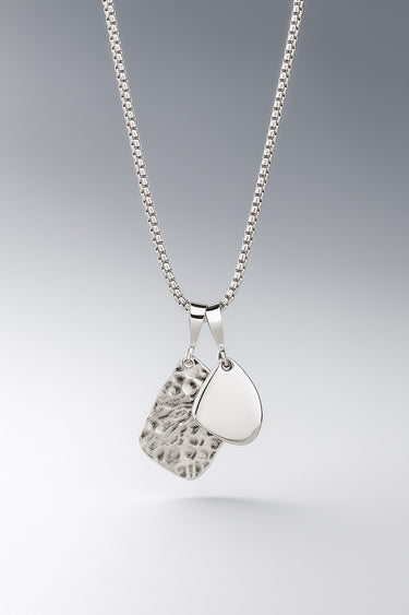 mens sterling silver amulet necklace with layered textured pendants on box chain close up minimal jewelry