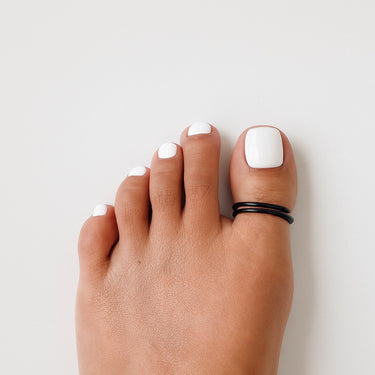 Top angle of black anodized aluminum big toe ring — comfortable open-band style.