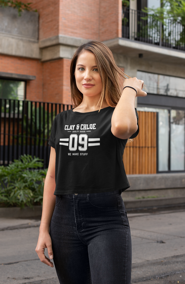model wearing black crop top with white font Clay and Chloe logo