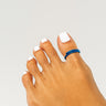 Dark blue anodized aluminum big toe ring on toes — smooth rounded fit, COLORS Collection by Clay & Chloe Jewelry.