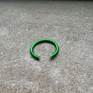 Green metal ring on a concrete surface