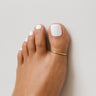 Gold anodized aluminum big toe ring on toes — smooth rounded fit, COLORS Collection by Clay & Chloe Jewelry.