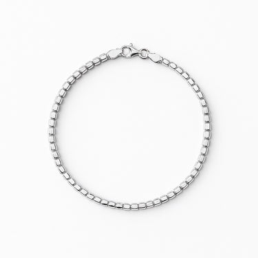A 2.5mm sterling silver cube chain bracelet with a high-polish finish and secure lobster clasp, displayed against a light grey background.
