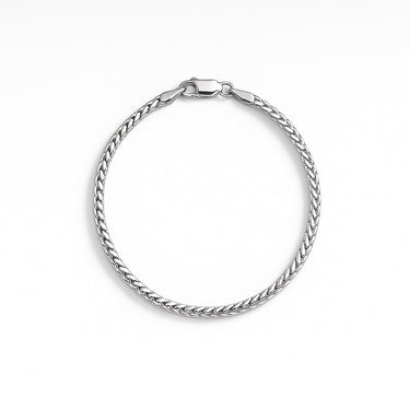 A 2.5mm sterling silver round box chain bracelet with a high-polish finish and a secure lobster clasp, displayed against a light grey background.

