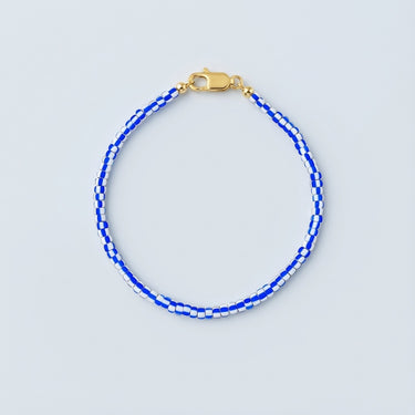A 3mm vintage African chevron glass bead bracelet featuring classic star-patterned beads and a high-polish gold lobster clasp.
