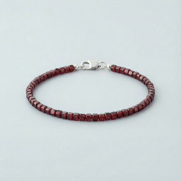 A 3mm faceted Garnet cube bead bracelet with a high-polish silver lobster clasp, highlighting the deep red crystalline structure.
