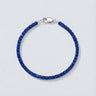 A 3mm faceted Lapis Lazuli cube bead bracelet featuring deep blue tones and a high-polish silver lobster clasp, displayed against a light grey background.
