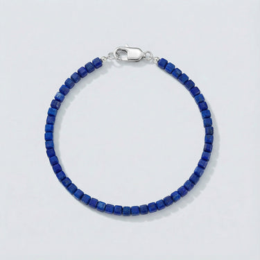 A 3mm faceted Lapis Lazuli cube bead bracelet featuring deep blue tones and a high-polish silver lobster clasp, displayed against a light grey background.
