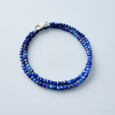 A 3mm faceted Lapis Lazuli cube wrap bracelet coiled in a double loop with a high-polish silver lobster clasp.

