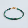 A 3mm faceted tourmaline cube bead bracelet featuring deep green tones and a high-polish gold lobster clasp.
