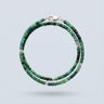 A 3mm faceted tourmaline cube wrap bracelet featuring deep green tones and a high-polish silver lobster clasp.
