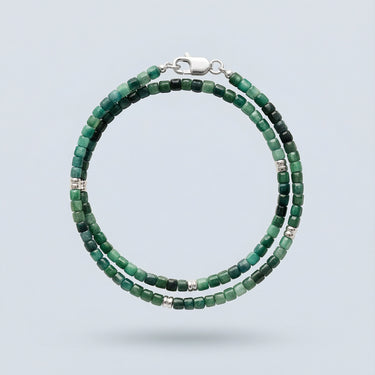 A 3mm faceted tourmaline cube wrap bracelet featuring deep green tones and a high-polish silver lobster clasp.
