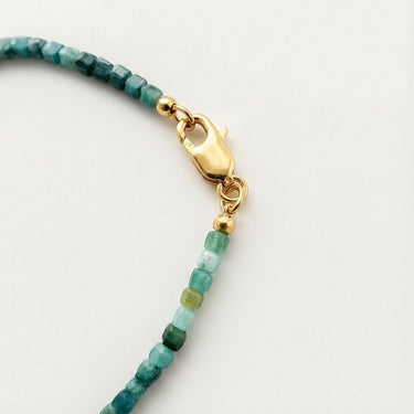 Close-up of a men’s necklace with 3mm faceted tourmaline beads and a polished 14K gold-filled lobster clasp.