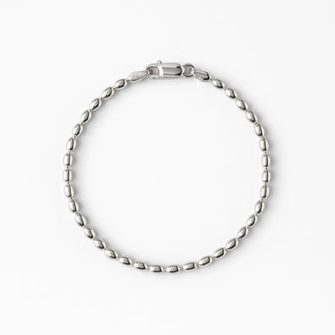 A 3mm sterling silver bracelet featuring elongated oval rice-shaped beads and a secure lobster clasp.
