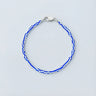 A 3mm vintage African chevron glass bead bracelet with high-contrast blue and white patterns and a high-polish silver lobster clasp.
