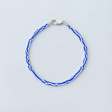 A 3mm vintage African chevron glass bead bracelet with high-contrast blue and white patterns and a high-polish silver lobster clasp.
