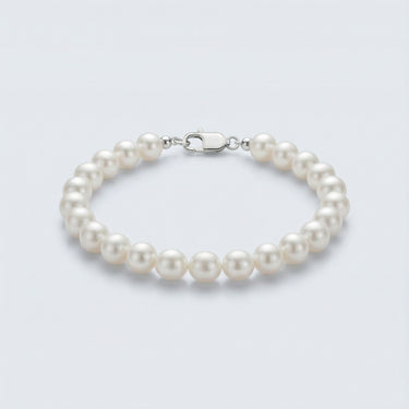 A 4-5mm white baroque freshwater pearl bracelet featuring unique organic shapes and a high-polish silver lobster clasp, displayed against a light grey background.
