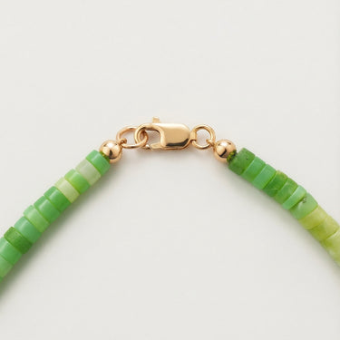 Close-up of a men’s 4mm African green chrysoprase heshi necklace featuring a polished 14K gold-filled lobster clasp.
