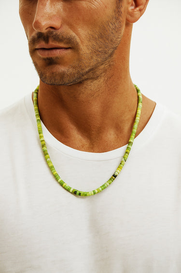 Front view of a model wearing an architectural 4mm African green chrysoprase heshi necklace.
