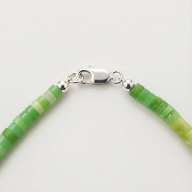 Close-up of a men’s 4mm African green chrysoprase heshi necklace featuring a polished Sterling Silver lobster clasp.
