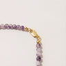Close-up of a men’s necklace with 4mm purple amethyst beads and a polished 14K gold-filled lobster clasp.