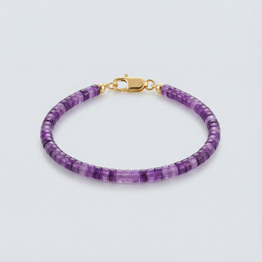 A 4mm purple Amethyst heishi bead bracelet with a high-polish gold lobster clasp, displayed against a light grey background.
