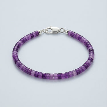 A 4mm purple Amethyst heishi bead bracelet with a high-polish silver lobster clasp, displayed against a light grey background.
