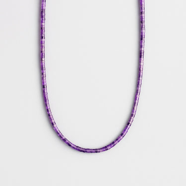 A single strand of 4mm purple amethyst heishi beads displayed in a U-shape against a neutral light grey background.
