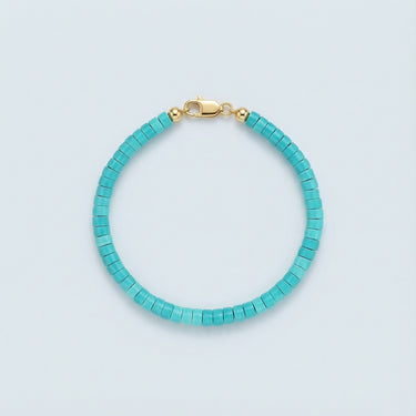 A 4mm sky-blue turquoise heishi bead bracelet with a high-polish gold lobster clasp, displayed against a light grey background.
