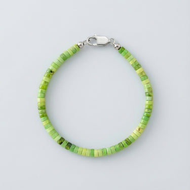 A 4mm African green chrysoprase heishi bead bracelet with a high-polish silver lobster clasp, displayed against a light grey background.

