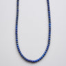 A 4mm deep blue lapis lazuli bead necklace displayed in a U-shape against a bright white background.
