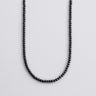 A strand of 4mm matte black onyx beads displayed in a U-shape against a neutral light grey background.
