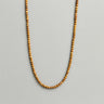 A strand of 4mm earth-toned picture jasper beads displayed in a U-shape against a neutral light grey background.
