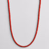 A 4mm vibrant red agate bead necklace displayed in a U-shape against a neutral light grey background.
