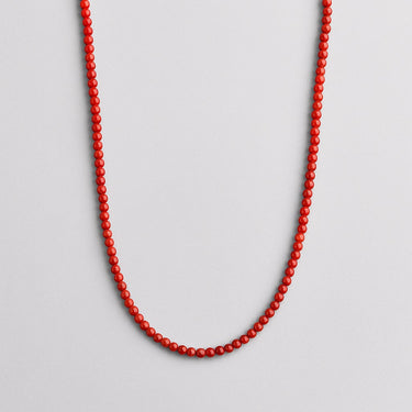 A single strand of 4mm vibrant red agate beads displayed in a U-shape against a neutral light grey background.
