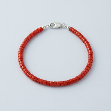 A 4mm vibrant red agate heishi bead bracelet with a high-polish silver lobster clasp, displayed against a light grey background.
