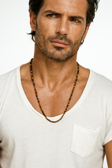 A male model wearing a white v-neck t-shirt showcasing the warm, golden-brown luster of a 4mm Tiger's Eye beaded necklace.
