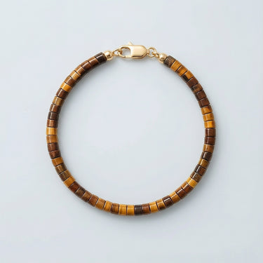 A 4mm golden-brown Tiger's Eye heishi bead bracelet with a high-polish gold lobster clasp, displayed against a light grey background.
