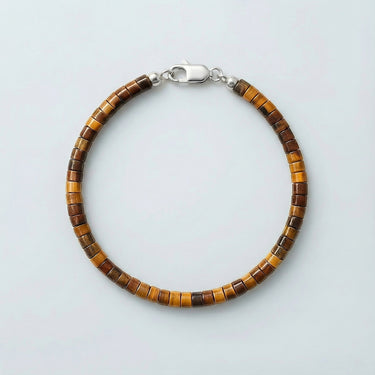 A 4mm Tiger's Eye heishi bead bracelet with a high-polish silver lobster clasp, displayed against a light grey background.
