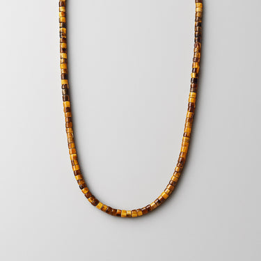 A single strand of 4mm golden-brown Tiger's Eye heishi beads displayed in a U-shape against a neutral light grey background.
