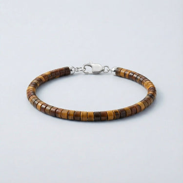 An angled view of a Tiger's Eye heishi bracelet showcasing the natural chatoyancy and smooth bead transitions.
