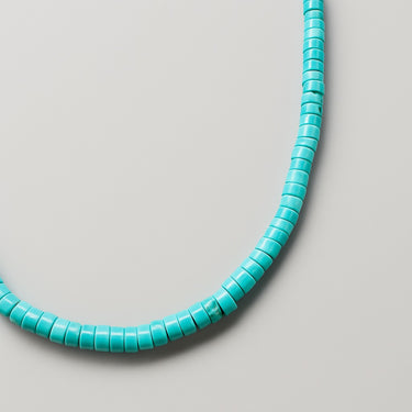 Macro shot highlighting the structural silhouette and natural texture of 4mm turquoise heshi beads.
