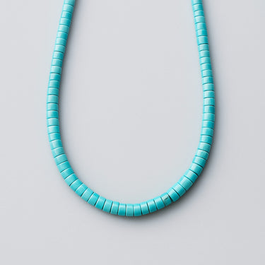 Front view of a men’s necklace featuring a solid strand of 4mm vibrant turquoise heshi beads on a white background.
