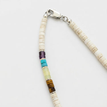 Close-up of a men's multi-stone heshi necklace featuring 4mm white turquoise beads and a polished sterling silver lobster clasp.
