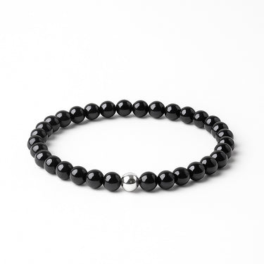 A 6mm Gloss Black Onyx round bead bracelet featuring a single sterling silver accent bead, displayed against a light grey background.
