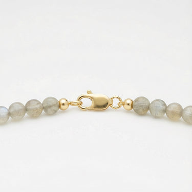 Close-up of a men’s necklace with 6mm labradorite beads and a polished 14K gold-filled lobster clasp.