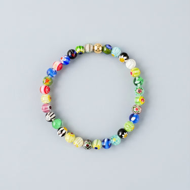 A 6mm handmade Millefiori glass bead bracelet with vibrant multi-color patterns and a single 14K gold-filled accent bead.
