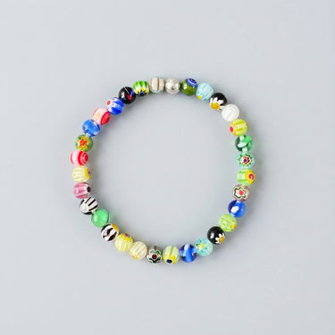 A 6mm handmade Millefiori glass bead bracelet featuring a kaleidoscope of floral patterns and a single sterling silver accent bead.
